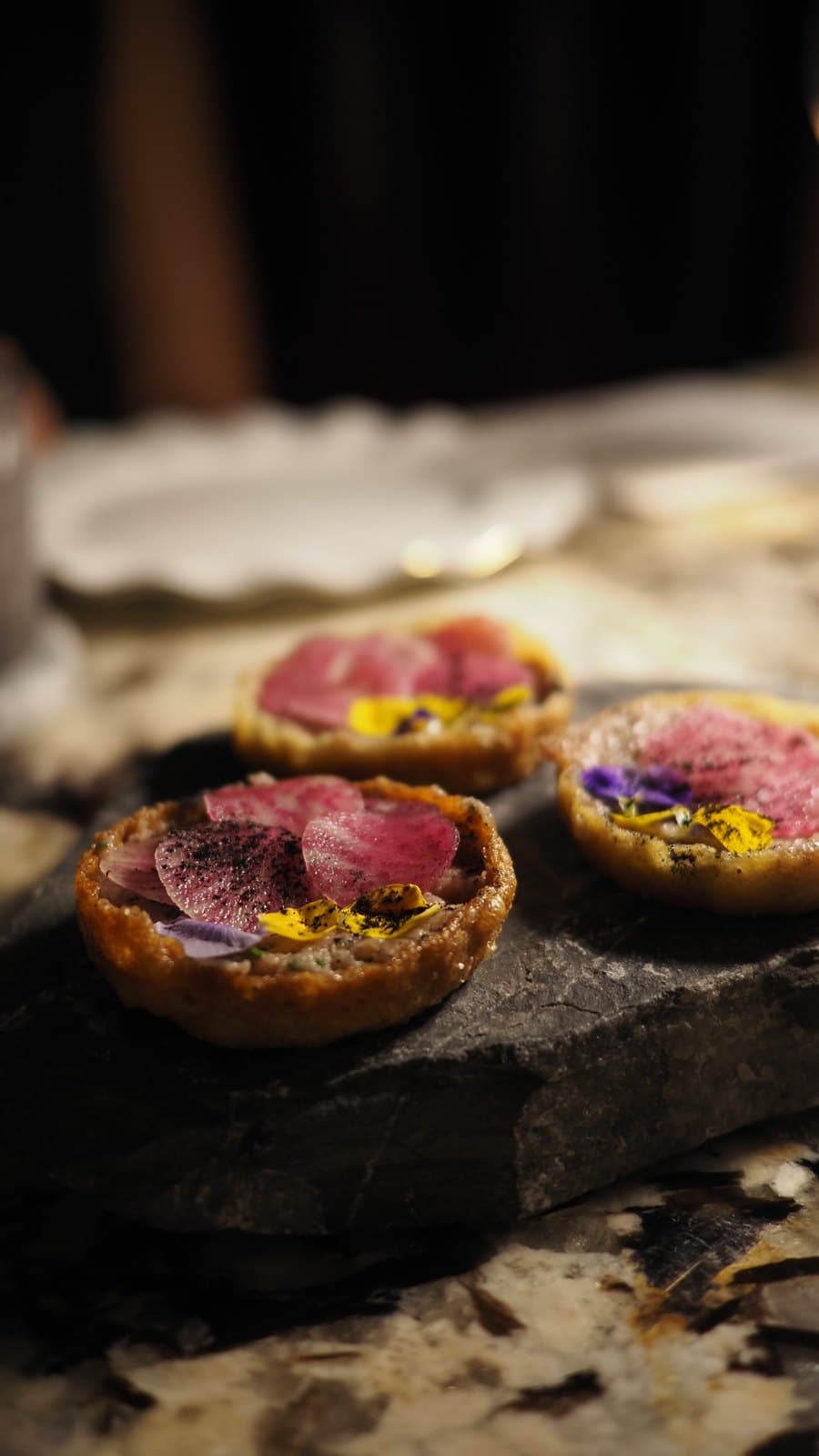 Crunchy beef tartare with truffle at Caleta, served in small tartlets on slate