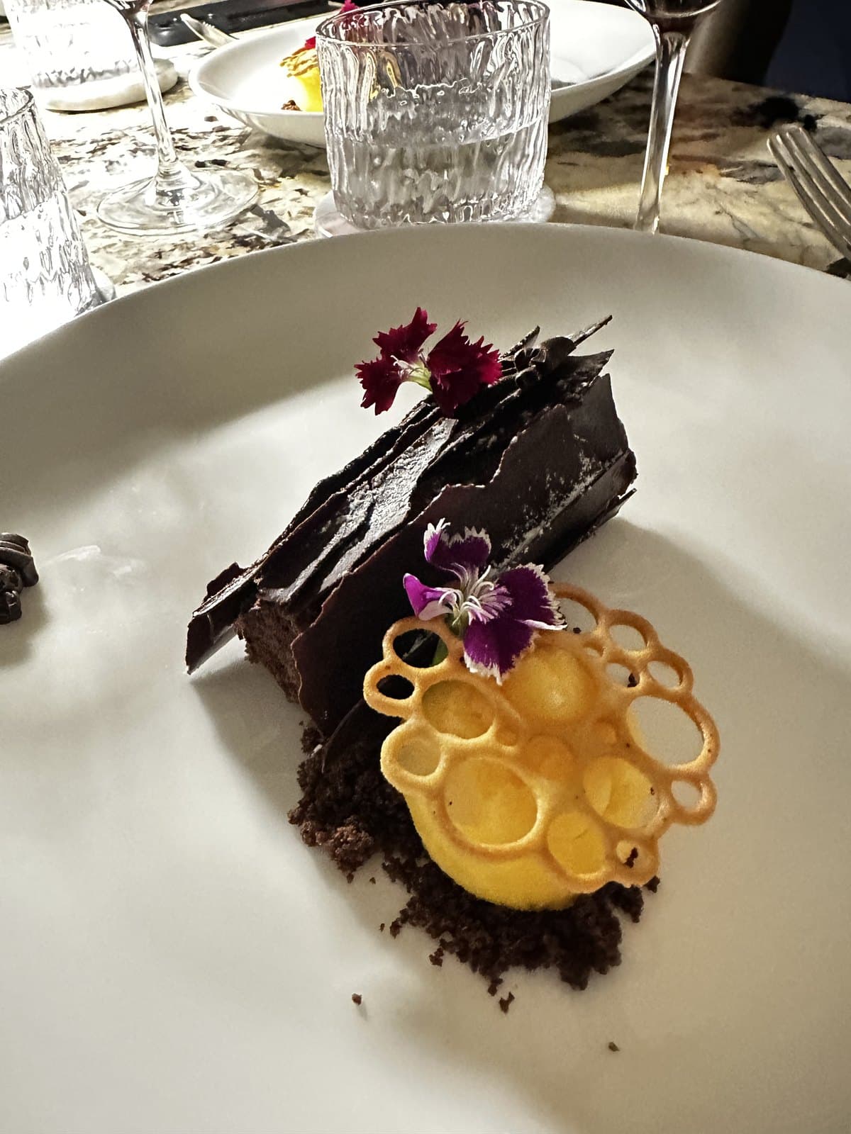 The Buche de Noel at Caleta: a dark chocolate slab with honeycomb and an edible flower