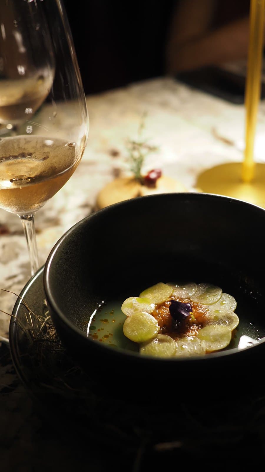 Kampachi sashimi with caviar and ceviche mayonnaise at Caleta, in a dark bowl