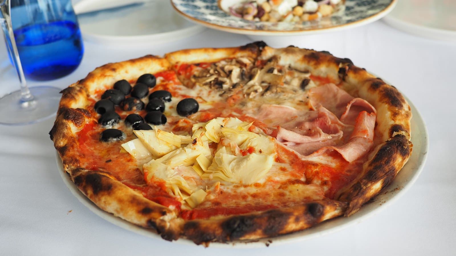 A Pizza 4 Stagioni at La Vespa Vista Mare with ham, olives and artichoke