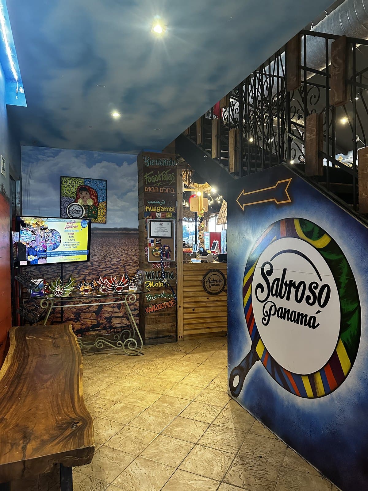 The way in to Sabroso Panama, past a mural and a hand-painted sign