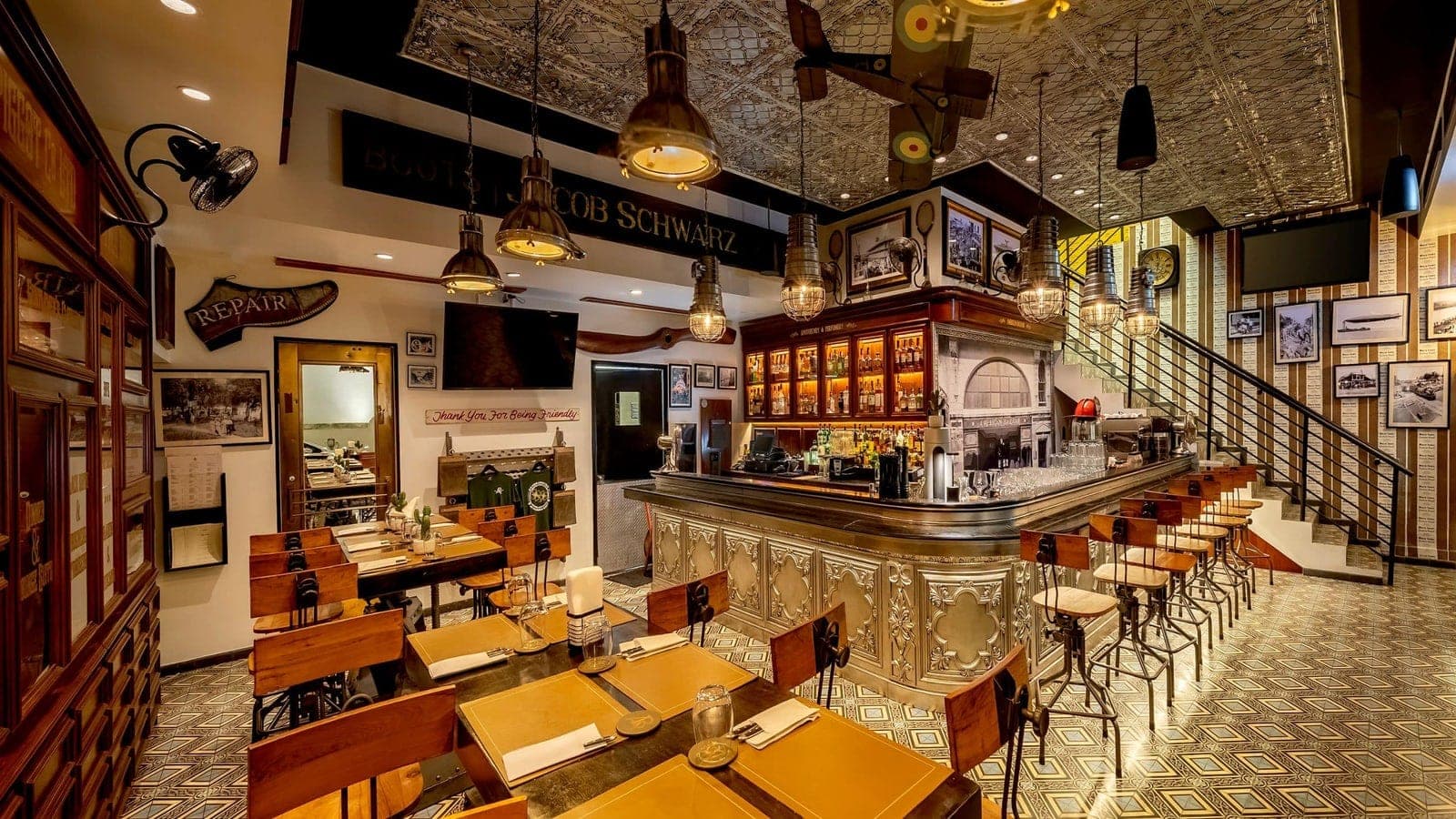 Dining room with a silver-clad bar and vintage aviation decor at American Bazaar, Hotel La Compañía, Casco Viejo, Panama City