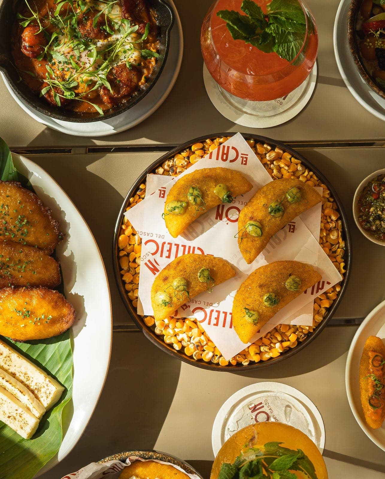 Flat-lay of Panamanian dishes with empanadas and fried plantains at Callejon del Casco, Casco Viejo, Panama City
