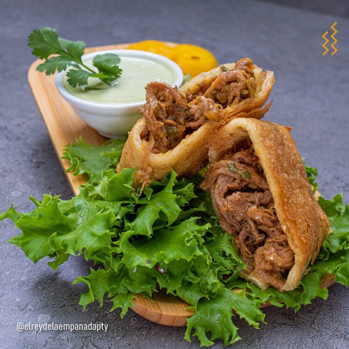 Fried beef empanadas cut open with green sauce at El Rey de la Empanada, El Cangrejo, Panama City