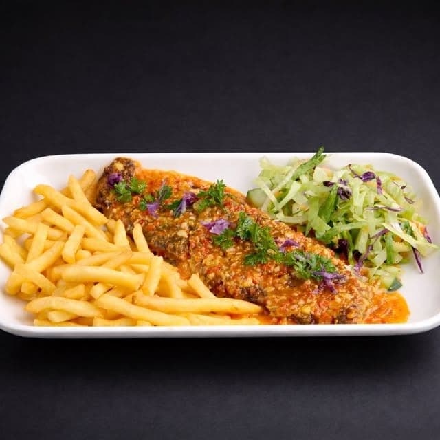 Fried fish fillet with fries and salad at La Polleria, San Francisco, Panama City