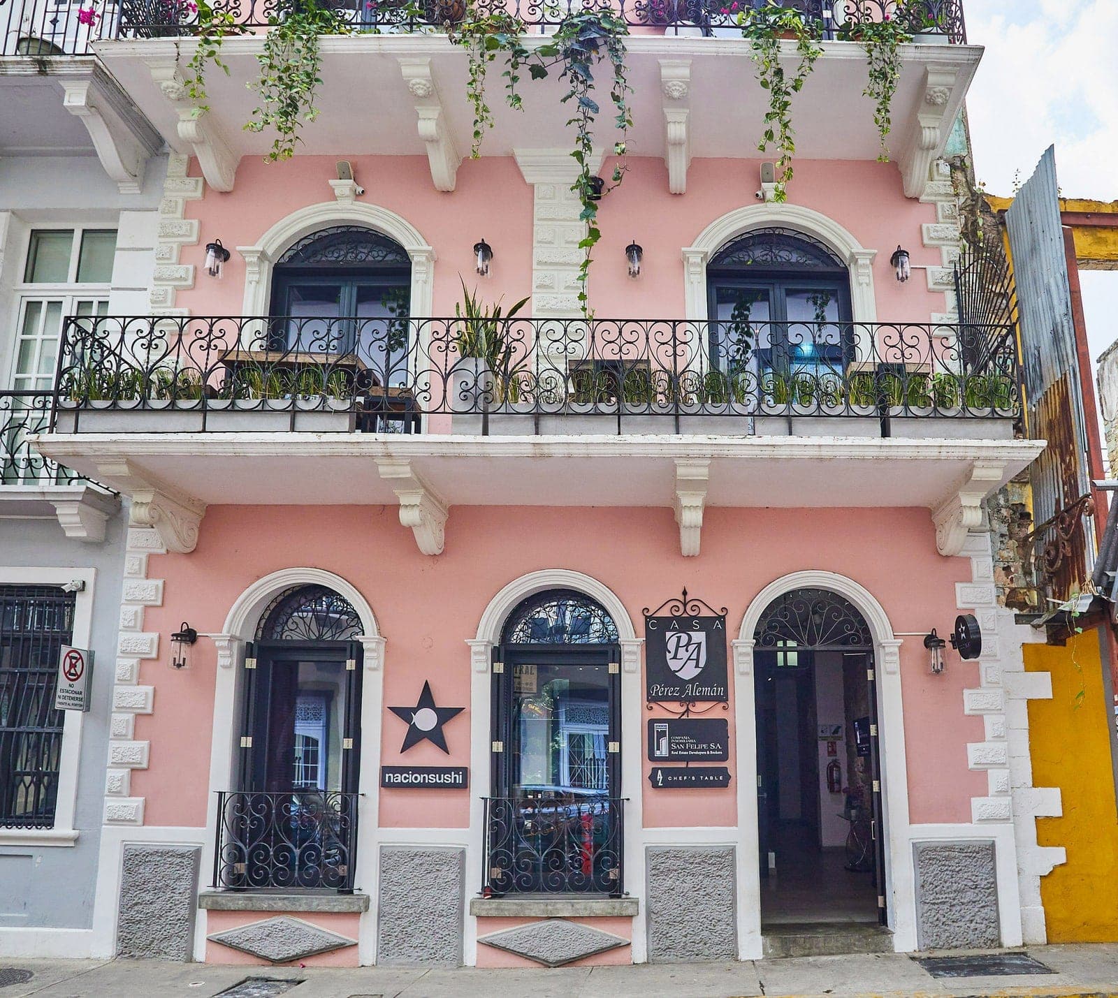 Pink two-story colonial facade of Nación Sushi Casco Viejo, Panama City
