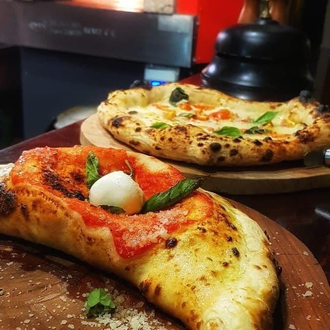 Two wood-fired Neapolitan margherita pizzas at Pizzaiolo Edilio, San Felipe, Casco Viejo, Panama City