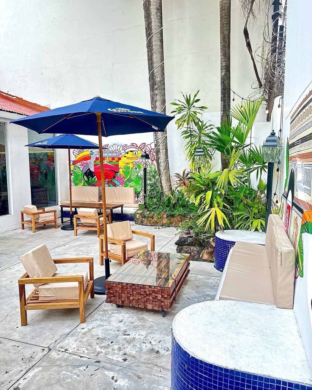 Outdoor terrace with tropical mural at Chez Didi, Bella Vista, Panama City